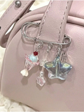 Broche con dijes de copa de helado y estrellas